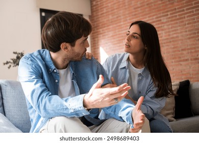 One young adult man talking bad with girlfriend about jealousy and cheating in relationship. Problems in marriage with upset male. Wife explaining him to be not guilty and cheater.People upset - Powered by Shutterstock