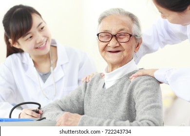 One Young Asian Female Doctor Doing Health Check To Senior Chinese Woman, Senior People Health Care