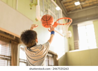 One young boy playing basketball. - Powered by Shutterstock