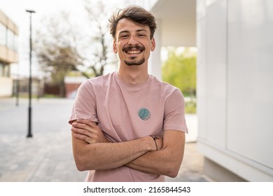 One Young Caucasian Man With Brown Hair And Mustaches Wearing T-shirt Looking To The Camera Modern Happy Adult Male Smile Confident Portrait In Front Of White Wall Copy Space Waist Up