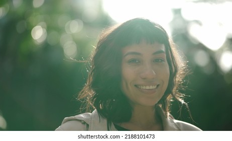 One Young Hispanic Woman Standing Outside With Sun Flare Shining. Portrait Of A South American Girl In Her 20s