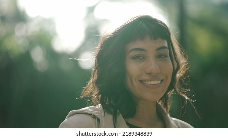 One Young Hispanic Woman Standing Outside With Sun Flare Shining. Portrait Of A South American Girl In Her 20s