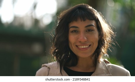 One Young Hispanic Woman Standing Outside With Sun Flare Shining. Portrait Of A South American Girl In Her 20s