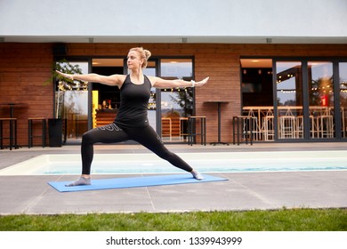 One Young Lady,20-29 Years, Old Doing Yoga On A Yoga Matt In A Backyard Of A Beautiful Fancy House.