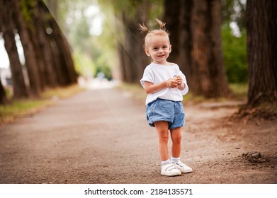 One Young Little Child Walking, Strolling Through A Green Field, Rural Forest Area Walk, School Age Girl Wandering Alone, Copy Space. Serene Outdoor Scene, Children Healthy Active Lifestyle Concept