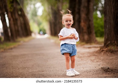 One Young Little Child Walking, Strolling Through A Green Field, Rural Forest Area Walk, School Age Girl Wandering Alone, Copy Space. Serene Outdoor Scene, Children Healthy Active Lifestyle Concept