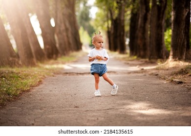 One Young Little Child Walking, Strolling Through A Green Field, Rural Forest Area Walk, School Age Girl Wandering Alone, Copy Space. Serene Outdoor Scene, Children Healthy Active Lifestyle Concept