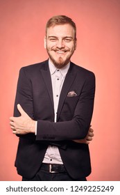 One Young Man, Wearing Suit And Shirt, 20-29 Years Old, Looking To Camera, Candid Smiling Happy, Looking Friendly. Real Person, Not Model. Pink Background, Studio Shot, Photo Shoot.