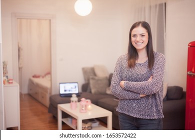 One Young Smiling And Happy Woman, Portrait At Her Ordinary Small Apartment.