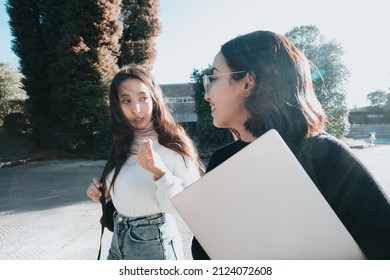 One young woman student explaining something to her friend. Chit chat small talk at university concept. Funny story and daily anecdote of students, gossip girls