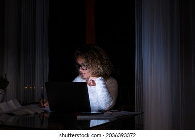 One Young Woman Using Laptop And Working On A Computer At Night At Home. Businesswoman At Job In His Office