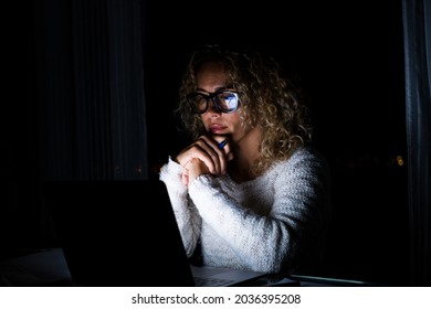 One Young Woman Using Laptop And Working On A Computer At Night At Home. Businesswoman At Job In His Office