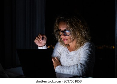 One Young Woman Using Laptop And Working On A Computer At Night At Home. Businesswoman At Job In His Office