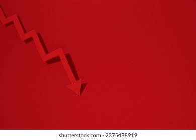 One zigzag paper arrow on red background, top view. Space for text