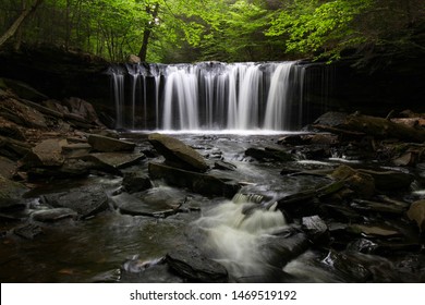 Oneida Falls, a beautiful waterfall in Ganoga Glen of the Ricketts Glen State Park, Pennsylvania, USA. Green, nature background. Hiking, active lifestyle. Long exposure.