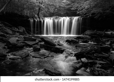 Oneida Falls, a beautiful waterfall in Ganoga Glen of the Ricketts Glen State Park, Pennsylvania, USA. In black and white. Nature background. Hiking, active lifestyle. Long exposure.