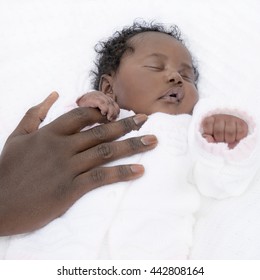 One-month-old baby girl holding her fatherâ??s hand
