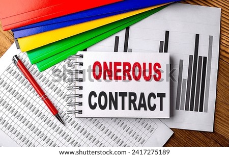 ONEROUS CONTRACT text on a notebook with pen, folder on a chart background