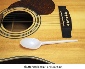 one-time spoon on a guitar, the concept of making money on food. closeup