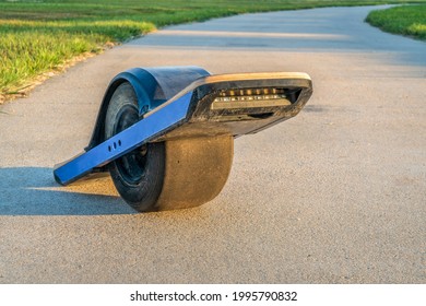 One-wheeled Electric Skateboard (personal Transporter) On A Paved Bike Trail