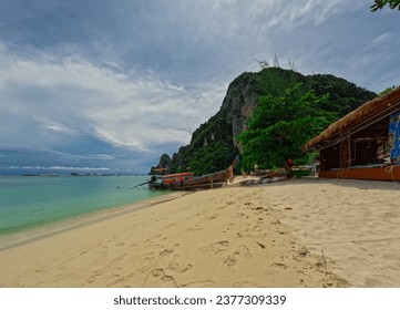 ong tail Boat Phi Phi island one of the wonders of beauty just off the coast of phuket thailand. Phi phi island is famous for turquoise clear blue waters teaming with Corel reef fish white soft sand 