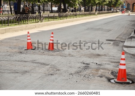 Ongoing Road Construction Work Featuring Traffic Cones on a Busy City Street Area
