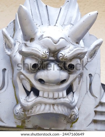 Onigawara, Japanese ornament, depicts demon or ogre faces, warding off evil spirits, adding cultural charm to architecture.