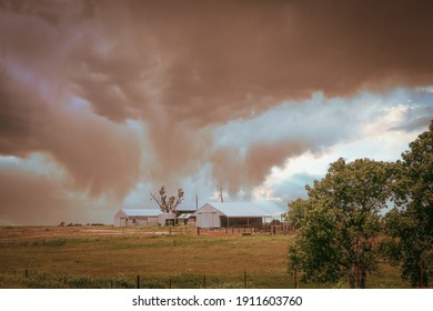 Onimous Looking Dust Storm Blowing In Over Western Oklahoma Farm With Barns And Pasture.