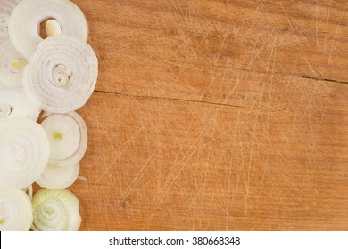 Onion rings on wooden cutting table