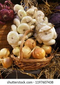 Onions and garlic in a wicker basket. Different size and sorts. Harvest market.  Thanksgiving Day. Crop.                               