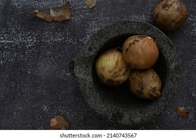 Onions In A Mortar Bowl And Beside The Bowl, Placed On A Coloured Background. Still Life Food Photography