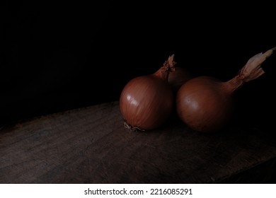 Onions On Cutting Board In Low Light