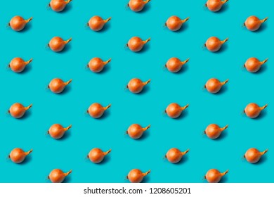 Onions pattern on a blue background, flat lay. Top view.
