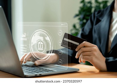 Online banking concept, Businesswomen using mobile phone and credit card with digital bank icon with indicators on laptop screen. - Powered by Shutterstock