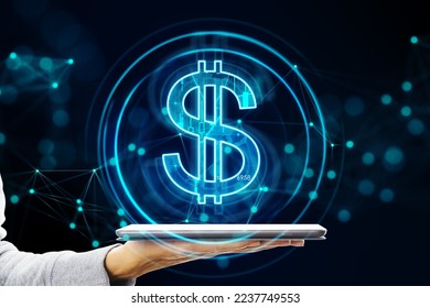 Online banking, digital money exchange and financial application concept with virtual blue dollar sign projected from digital tablet in man hand on dark background - Powered by Shutterstock