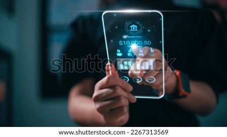 Online banking and internet banking concept. Women use smartphones for personal financial transactions on mobile banking on futuristic virtual interface screen app. check bank account balance.