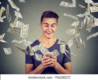Online banking money transfer, e-commerce concept. Young man using smartphone with dollar bills flying away from screen