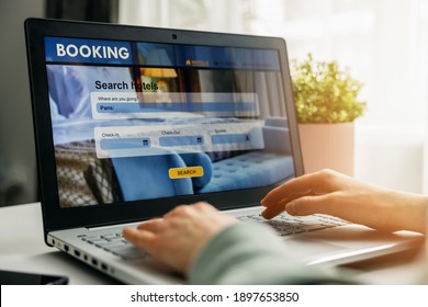 Online Booking - Person Using Laptop For Hotel Search And Reservation