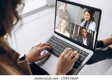 Online Business Meeting. Business Team Working From Home In A Video Conference. 
The Girl Communicates Via Video Call Communication Using Laptop With Her Business Colleagues About The Future Strategy