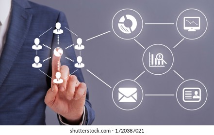 Online Business Process Management concept. Businessman hand pressing globe icon on digital scheme of business process