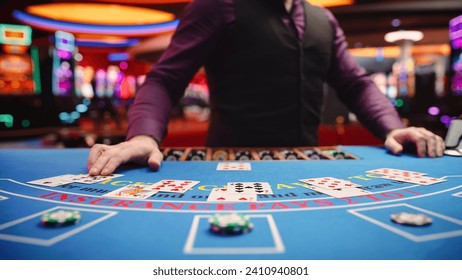 Online Casino: Professional Croupier Deals Cards on Blackjack Table: Anonymous Male Game Dealer Masterfully Revealing possible Jackpot Winning Hand, Excitement in High Stakes Game. Closeup shot