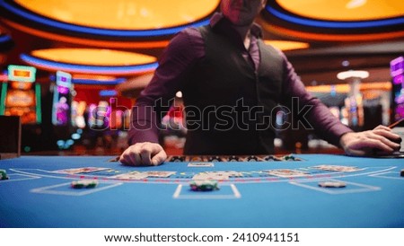 Online Casino: Professional Croupier Deals Cards on Blackjack Table. Anonymous Dealer Masterfully Revealing Jackpot Possibly Winning Hand, Excitement in High-Stakes Game for Payout. Close-Up Shot