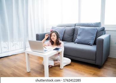 Online class learning student studying lockdown quarantine homeschooling distance learning education, Asian beautiful girl living room study at home computer laptop note book video call communication - Shutterstock ID 1762412285