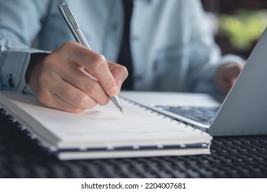 Online Class, Student Writing On Notebook While Study At Home. Young Adult Woman Doing Online Lesson By Using Laptop Computer, Digital Technology Education, Working At Home