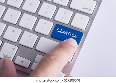 Online Concept: Finger Pressing Submit Claims Button On Keyboard