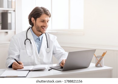 Online concilium. Young doctor conversating with colleagues via laptop online, empty space