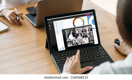 Online Conference. Video Presentation. Professional Webcast. Female Employee Using Laptop Working On Data Review With Business Team On Screen With Charts Graphs.