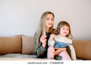 Online Consultation With A Pediatrician. Mom And Baby Girl At The Doctor's Appointment.Doctor Medical Online Call. Doctor Therapist Psychologist Speaks With Couple Video Chat Using A Laptop