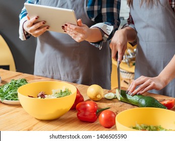 Online Cookery Course. Vegetarian Diet Recipe. Cropped Shot Of Mother And Daughter Making Salad With Organic Vegetables.