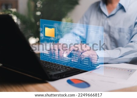 Online data and document system smart digital marketing analysis and data management concept, Businessman use laptop manage documents systematically and keep in security folder on virtual screen 